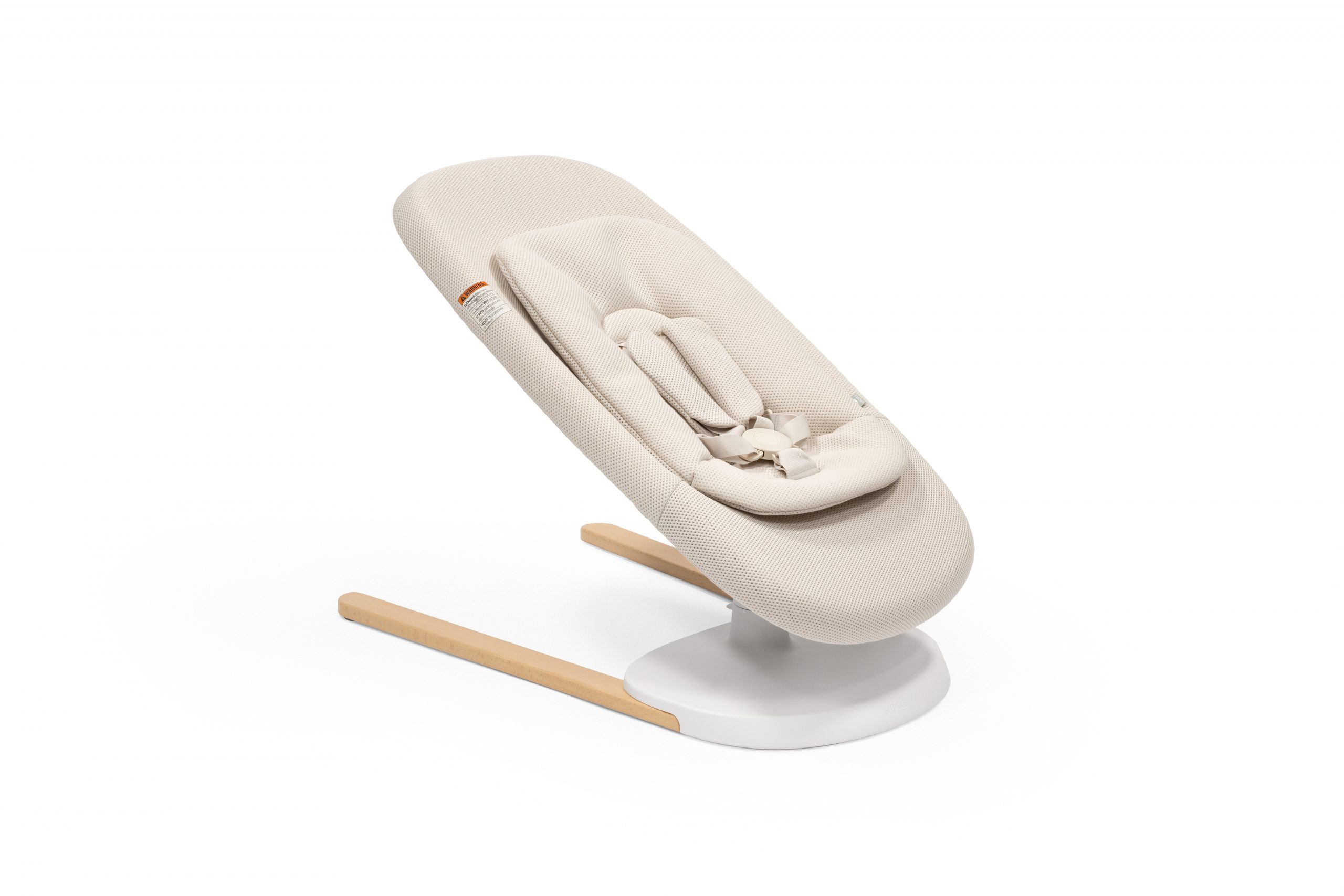 Stokke® Yoga™ Bouncer Light Sand. Low position with inlay. Angled view. US variant. Stokke® Yoga™ Bouncer Light Sand. Low position with inlay. Angled view. US variant.